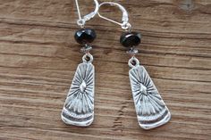 "These boho dangle earrings feature beautiful czech glass beads hanging from sterling silver leverback and sterling silver head pins. Plus, they're made with antique silver plated ethnic charm (28x12mm), giving them a unique rustic look. At just 2-1/4 inches long, these earrings are the perfect accessory for any outfit. Color : Black faceted czech glass beads Finish : Sterling Silver lever back, Sterling Silver head pins, Antique Silver plated ethnic charm (28x12mm) and antique silver plated spacer beads. Length: 2-1/4 inches including the sterling silver leverback Ear wire : Sterling Silver lever backs. Your pair of earrings will arrive carefully packed in a kraft box jewelry with ribbon, perfect for gift giving to a loved one...or to yourself. Please note if you order more than one item,