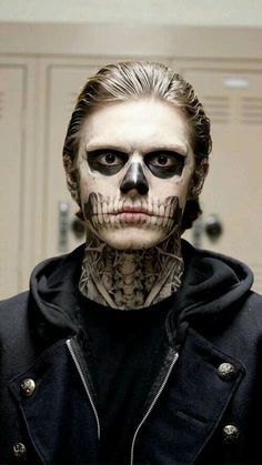 a man with his face painted like a skeleton