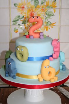 there is a cake that has the number two on it and some animals around it