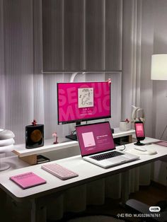 a laptop computer sitting on top of a desk next to a phone and mouse pad