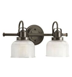 two light bathroom fixture with frosted glass shades on the sides and an old - fashioned metal finish