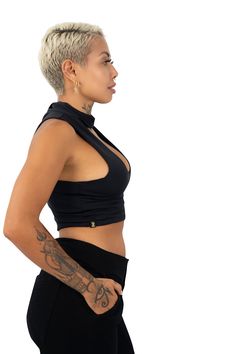 Sporty. Comfortable. Dressy. The Kenya Collar Top is the choker crop top that goes from gym to cocktail hour with ease. FEATURES: Soft yet sturdy construction with four-way stretch Seamless Choker style collar neck with button fastener Keyhole V neckline Double layered for modesty Crafted from 78% ECONYL® yarn (recycled plastic) and 22% Lycra Xtra Life (special spandex designed for excessive wear & tear) Ethically made in-house at our studio in Bali SIZING: Please note we design using the metric High Stretch Cropped Party Tops, High Stretch Cropped Tops For Party, Versatile Fitted Black Crop Top, High Stretch Cropped Top For Club, Black Stretch High Neck Crop Top, Chic High-stretch Crop Top For Club, Chic High Stretch Crop Top For Club, Edgy Stretch Crop Top, High Stretch Black High Neck Crop Top