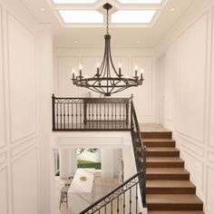 a staircase leading up to the second floor in a house with white walls and wood floors