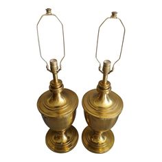 pair of brass table lamps on pedestals