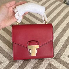 New Condition. Never Been Used. Dust Bag Included. Tan Square Evening Bag, High-end Red Box Bag For Shopping, Luxury Red Box Bag With Dust Bag, Modern Red Bag With Metal Hardware, High-end Red Satchel Box Bag, Modern Red Shoulder Bag With Metal Hardware, Luxury Tan Bag With Chain Strap, Luxury Red Square Bag, High-end Red Shoulder Bag With Branded Hardware