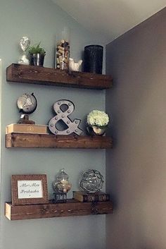 three wooden shelves with decorative items on them in the corner of a room next to a bed