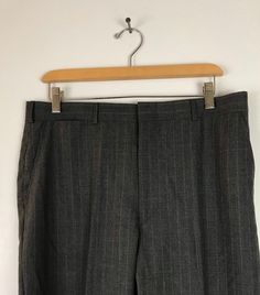 "-Description- >men's dark gray dress pants with white & red pinstripes >clip and zipper front >belt loops >open pockets in the front >one open and one button close pocket in the back >size 34 waist >great for a dressy event! >condition: very good >color(s): gray, red, white >fabric(s): woo. >brand: none >care: dry clean -Measurements- >size: 34 waist ✩ all measurements are taken with the item laying flat & some sizes are estimates so please check m Pinstripe Dress Pants For Business, Striped Dress Pants With Welt Pockets For Business, Striped Fitted Dress Pants For Business Casual, Fitted Striped Dress Pants For Business Casual, Fitted Striped Dress Pants With Welt Pockets, Fitted Vertical Striped Dress Pants For Business Casual, Fitted Striped Bottoms With Welt Pockets, Dark Gray Dress, Dress Pants Mens