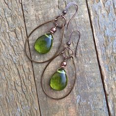 Green Czech Glass Teardrop and Copper hoop earrings.Spring green Czech glass teardrops dangle inside of a hand forged, antiqued copper hoop. Very light weight and a perfect color for spring and summer outfits!Product overview:- Made with Czech glass teardrops and antiqued copper- Total hanging length of 2" including ear wire- Light weight and versatile- Hypoallergenic, lead and nickel free ear wirespolicies* Please read shop policies before ordering, you can find this under the dropdown menu in Lapidary Jewelry, Teardrop Hoop Earrings, Spring And Summer Outfits, Diy Wire Earrings, Teardrop Jewelry, Green Chartreuse, Wire Crafts, Wire Earrings, Copper Earrings