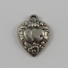 "This is a vintage \"Puffy Heart\" sterling silver charm for a charm bracelet.  It weighs .95 grams and measures 5/8\" X 3/4\", marked \"STERLING\" All charms come with a split ring to attach to a bracelet. We have hundreds of charms in stock. If you don't see what you are looking for in our shop please contact us as it is likely we have it. Inventory #13162" Shop Jewelry, Puffy Heart, Split Ring, Sterling Silver Charm, Vintage Charms, Sterling Silber, Jewelry Supplies, Arm Band, Jewelry Shop