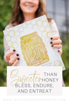 a woman holding up a sign with the words sweetest honey on it and an image of