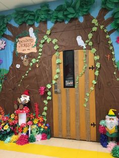 a classroom door decorated with paper flowers and gnomes in front of a tree trunk