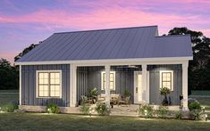 a small house is lit up at night with lights on the front porch and windows