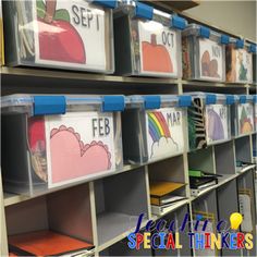 several plastic bins with pictures on them in a classroom storage area for children's books