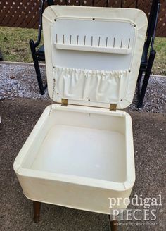 an old suitcase is sitting on the ground with it's lid open and seat up