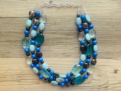 💞One of a kind & ready to ship💞  16 Inch Necklace with a 4 inch gold extender chain and silver lobster clasp. Shades of blue and black in glass and acrylic beads.  Thank you for supporting American small business! 100% handmade. *Smoke and pet free home!* Hate to wait? Me too! I ship 6 days a week. Thank you for browsing my store! Check out my other items here: https://www.etsy.com/shop/PolkaDotDrawer?ref=si_shop Hand-strung Blue Multi-strand Necklace, Blue Multi-strand Turquoise Necklace With Colorful Beads, Adjustable Multi-strand Turquoise Blue Necklace, Blue Beaded Multi-strand Crystal Necklace, Blue Turquoise Multi-strand Necklace With Polished Beads, 16 Inch Necklace, Chunky Statement Necklace, Blue Jewelry, Multi Strand Necklace