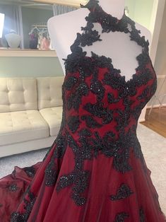 a red and black dress on display in a room