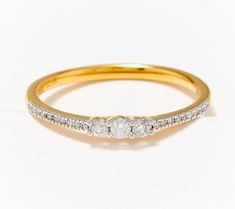 a three stone diamond ring on a white background