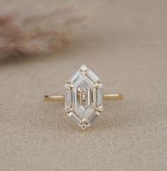 an emerald cut diamond ring with three baguets