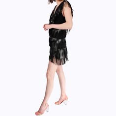 Vegan leather fringe high-low mini dress  Made of vegan leather fringe this look is rocker chic! The plunging neckline is balanced off with a more relaxed high-low skirt. The back neckline matches the front to create a V-open back. Outer 100% Polyester/ Lining: 100% Silk Do Not Machine Wash/ Delicate Dry Clean/ Do Not Bleach/ Do Not Tumble Dry Fringed Mini Dress For Night Out, Mini Flapper Dress With Fringe For Party Season, Party Season Fringe Mini Dress, Summer Mini Flapper Dress With Fringe, Chic Spring Flapper Dress, Chic Summer Flapper Dress With Fringe, Chic Fringe Flapper Dress For Party Season, Flapper Dress With Tassels For Party Season, Chic Night Out Flapper Dress