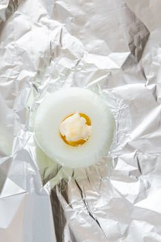 an egg is sitting on top of tin foil