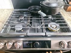 a stove top with pots and pans on it