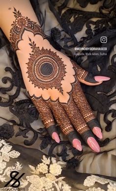 a woman's hand with henna on top of her arm and the bottom half of