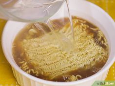 a bowl filled with soup being poured into it