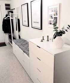 a room with white walls and pictures on the wall