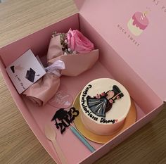 a pink box with a cake, fork and knife in it