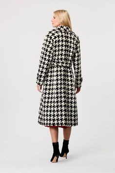 The bestselling Brandy coat is back with a bold new twist—houndstooth. Crafted from a woven fabric, this long trench jacket offers a heavier weight, perfect for cooler days. Its tailored fit allows for easy layering over chunky sweaters while maintaining a sleek silhouette. Design details include classic lapels, functional pockets, and a sash closure, making this houndstooth jacket both practical and stylish. Whether for work or weekend outings, the Brandy long trench jacket is a timeless additi Spring Houndstooth Double-breasted Outerwear, Wool Houndstooth Outerwear For Work, Houndstooth Long Coat For Fall, Long Houndstooth Coat For Fall, Chic Long Coat With Houndstooth Pattern, Plaid Double-breasted Houndstooth Outerwear, Wool Double-breasted Houndstooth Outerwear, Double-breasted Wool Houndstooth Outerwear, Spring Wool Outerwear With Houndstooth Pattern