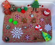 a bath tub filled with lots of christmas decorations on top of red carpeted floor