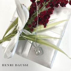 Make a statement in breathtaking luxury with this Henri Daussi Signed 1.14ct t.w. Diamond Cushion Brilliant Cut Halo Solitaire Pendant Necklace. Featuring premium quality natural diamond in a cushion-cut style, and a classic halo design, this luxurious necklace will become a treasured heirloom. Luxuriate in timeless elegance! Metal: 18K White GoldDiamond Shape: Cushion Brilliant CutDiamond Weight: Cushion Center Shape 1.01carat22 Round Brilliant Cuts: 0.13ct twChain Length: 16''- 17.5'' Estimated production time is 4 - 5 weeks. Luxurious Necklace, Henri Daussi, Necklace Guide, White Gold Pendant Necklace, Diamond Initial Necklace, Halo Design, Solitaire Pendant Necklace, Jewelry Appraisal, Bridal Engagement Rings