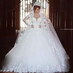 a woman in a white wedding gown and veil