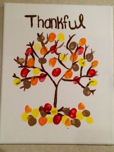 a handprinted thanksgiving tree with leaves and acorns on white paper that says, thank u