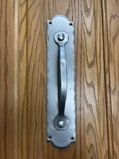 a metal handle on a wooden door