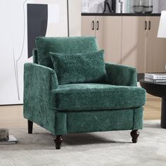 a green chair sitting on top of a rug next to a black table and lamp