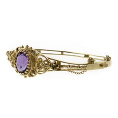 This is a perfect piece of fine jewelry history. A 14K yellow gold filigree bracelet with an oval 3.93ct amethyst secured by a stunning multi-prong setting. This bracelet has a fully functional hinge clasp and safety chain. The bracelet is in beautiful shape. Antique Oval Bangle For Formal Occasions, Oval Gemstone Bangle For Formal Events, Formal Amethyst Oval Cabochon Jewelry, Formal Amethyst Jewelry, Oval Cabochon, Formal Purple Oval Cabochon Jewelry, Oval Gemstone Bangle In Fine Jewelry Style, Elegant 14k Gold Oval Bangle, Elegant Oval Hallmarked Bangle, Elegant Oval 14k Gold Bangle