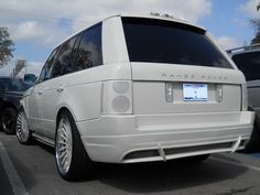 a white range rover parked in a parking lot