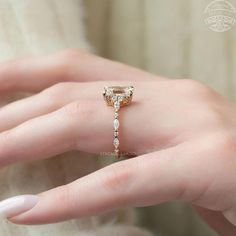 a woman's hand with a ring on it and a diamond in the middle