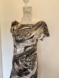 one off unique item. stand out in a crowd! white and black monochrome modern abstract printed dress. scooped neckline and short sleeve. backless with tie detail. loose fitting with asymmetrical full skirt shape. made from a lovely printed fabric with a subtle clear holo dot pattern on.  fabric has a slight stretch but isnt really stretchy like lycra. would fit uk size 12/14 Modern Short-sleeve Summer Dress, Modern Short Sleeve Summer Dress, Modern Summer Tops With Abstract Print, Rave Dance, Black Monochrome, Modern Abstract Print, Backless Long Dress, Abstract Print Dress, Scooped Neckline