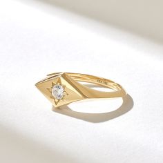 The Rhombus Northstar Signet Ring is a petite and elegant piece of jewelry that blends celestial motifs with geometric design. Crafted from high-quality 14k solid gold, this ring features a unique rhombus-shaped signet adorned with a small, sparkling diamond in the center. Features * Made to Order. * Gold KT: 10K, 14K, 18K * Width of Band: 1.87MM * Width of Top: 8.06x13.68MM * Thickness of Band: 1.31MM * Custom Gold Color: Rose Gold, Yellow Gold, White Gold * Diamond Color- Clarity: D-E-F color VVS clarity (excellent ideal cut) *Total Ctw: 0.12 ctw * Ready to Ship in 5-7 Business Days ✓ We care about the environment,the jewelry we cast is made with recycled gold. We source exclusively post-consumer material that is refined back to their pure elements to ensure that the gold is in the same 14k Gold Celestial Diamond Ring, Celestial 14k Gold Ring With Single Diamond, Celestial 14k Gold Diamond Ring, Celestial Single Diamond Promise Ring, Celestial Style Single Diamond Promise Ring, 14k Gold Single Diamond-shaped Jewelry, 14k Gold Diamond-shaped Ring, 14k Gold Diamond-shaped Ring Fine Jewelry, 14k Gold Diamond-shaped Diamond Ring As Gift