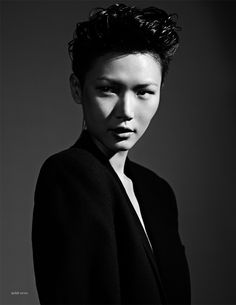 black and white photograph of a woman with short hair wearing a blazer over her shoulders