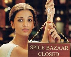 a woman holding a sign that says spice bazaar