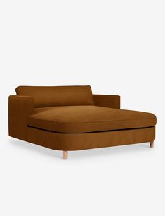 a brown couch sitting on top of a white floor