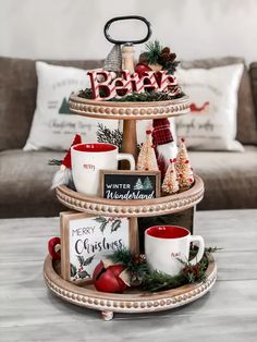 three tiered tray with coffee mugs and christmas decorations