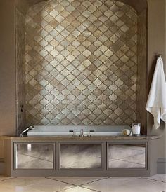 a bath room with a sink and a mirror on the wall next to a towel rack