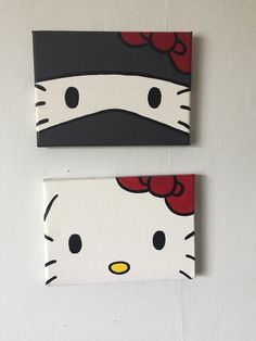 two hello kitty paintings are hanging on the wall