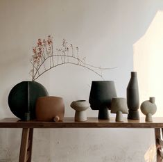 several vases are arranged on a wooden table