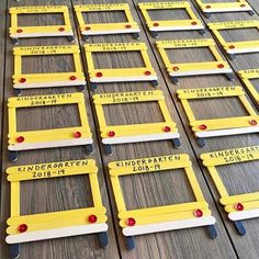 rows of yellow and white license plates with red pins on them sitting on a wooden floor