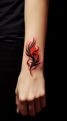 a woman's arm with a red and black tattoo design on the left wrist